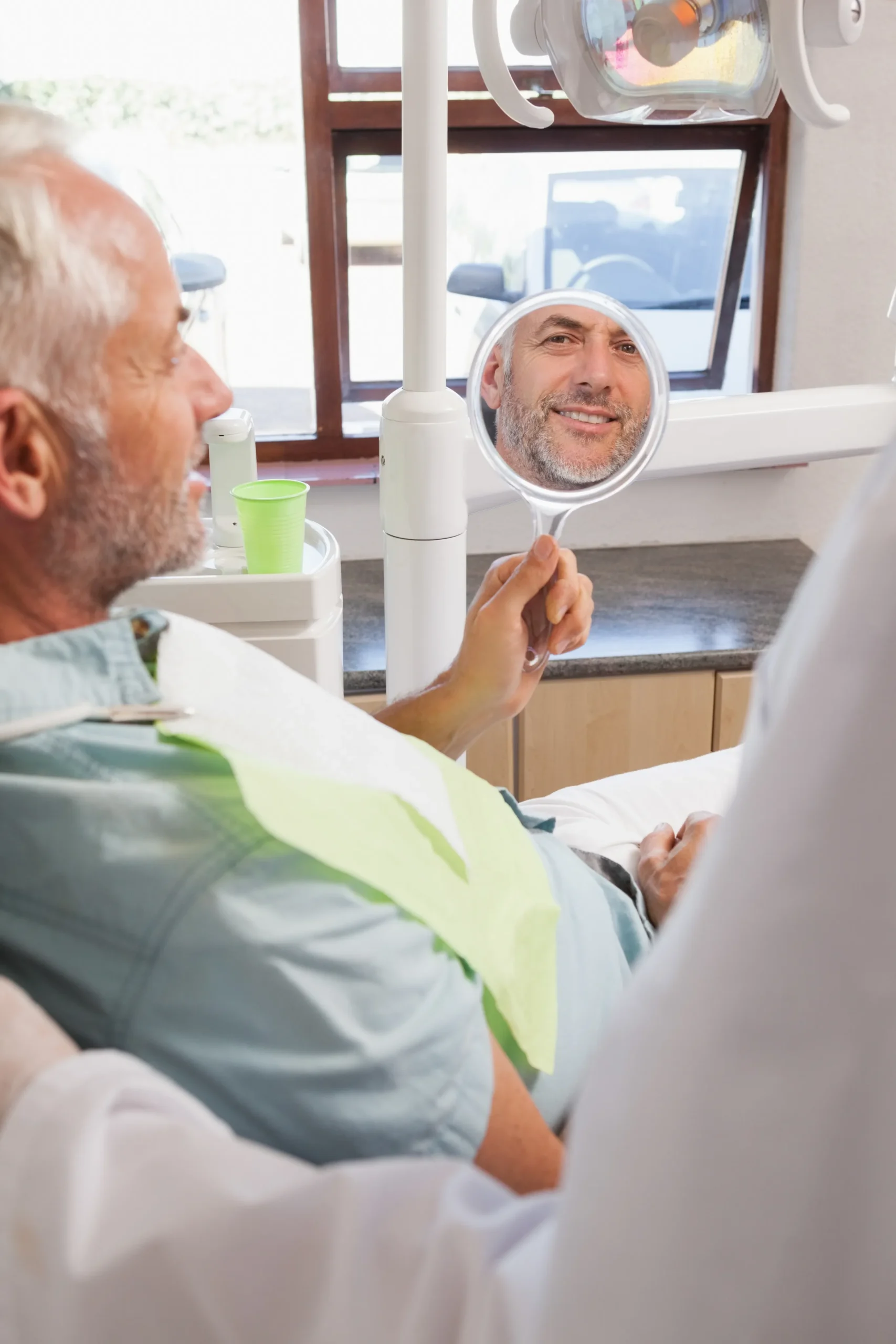 A male patient is looking in the mirror