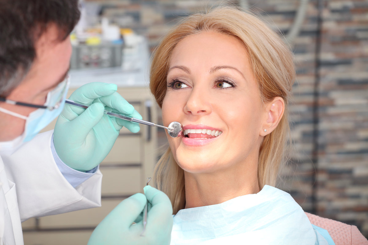 Portrait of healthy teeth patient sitting at dentist office for dental caries prevention.