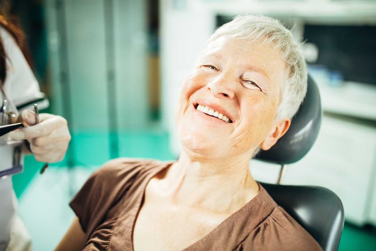 Senior female patient on a dentist appointment. Regular check up at orthodontist. Specialist examining a older patient. Dental prosthetics implant for retired pensioner woman