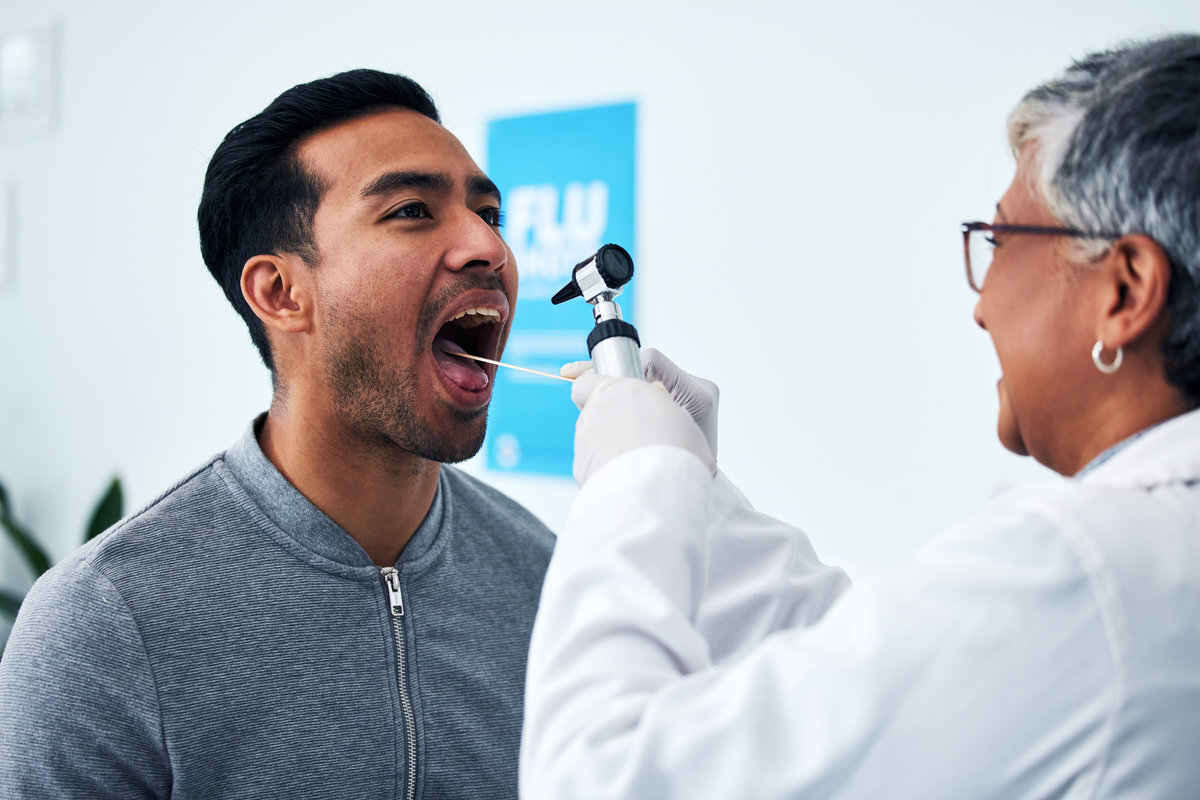 Medical, consulting and doctor with person and throat in hospital for cancer, dentist and surgery. Medicine, healthcare and check up with woman and patient in clinic for wellness, virus and oral exam.